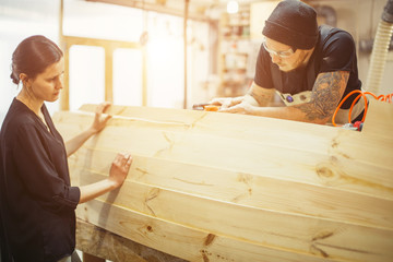 carpenter man in workshop glue wood work for construction