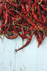 Red dried chilly on white wooden.