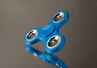 Modern spinner on mirror background