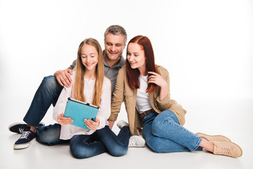 family using digital tablet