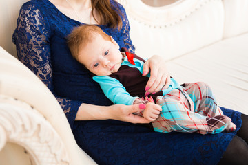 Adorable Caucasian baby with his mother. Portrait of a three months old baby boy