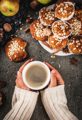 Autumn winter pastries. Vegan food. Healthy cookies, muffins with nuts, apples, oat flakes. Cozy atmosphere, warm blanket, girl drink coffee, hands in picture. Dark stone table. Copy space top view