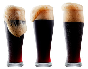 Mug of frosty dark beer with foam isolated on a white background