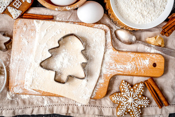 cooking christmas gingerbread on wooden background top view