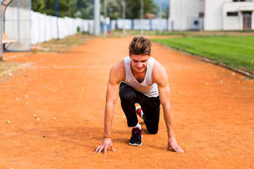Young caucasian boy training outdoor. Sport and muscle concept