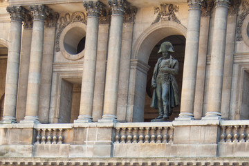 Statue of Napoleon Bonaparte in his uniform looking down from the balcony of Les Invalides. Paris, France