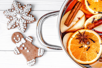 preparation of mulled wine in pot wooden background top view