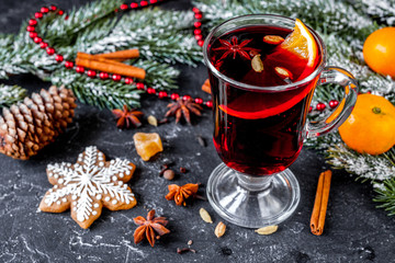 Christmas mulled wine with spices in cup on dark background