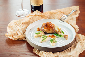 Marinated grilled chicken cooked on BBQ and served with herbs on a wooden board