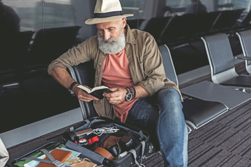 Serious man holding open book