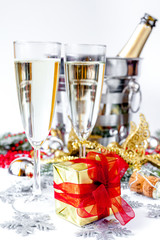 glasses of champagne and Christmas ornaments on white background