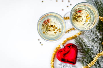 glasses of champagne and Christmas ornaments top view