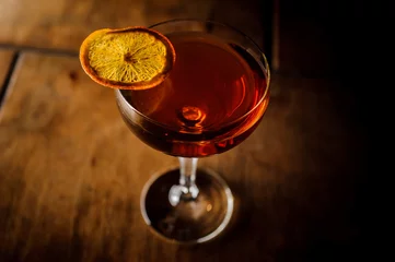 Fotobehang Manhattan cocktail decorated with an orange slice © fesenko