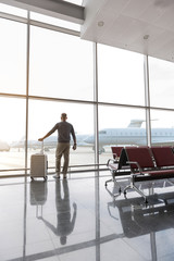 Adult man looking at casement in airport