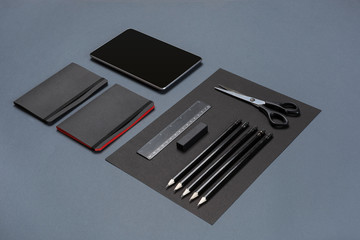 Set of black office stationery on a gray background, flat lay