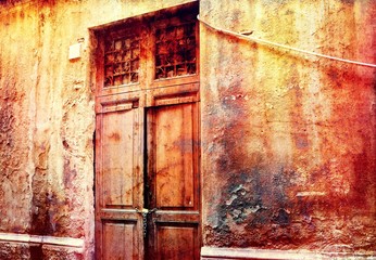 An old ruined street with a surreal-looking wooden door.