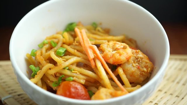 sprinkle orange carrot slice on Hokkien mee or Chinese fried noodle, Malaysia food