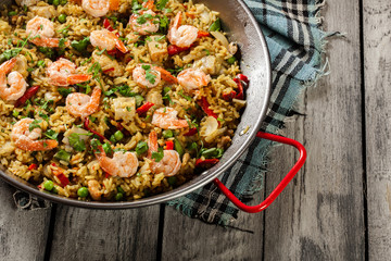 Traditional seafood paella with shrimp, fish and chicken seved i