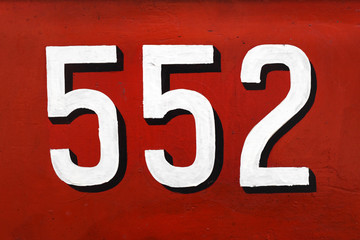 Fototapeta na wymiar White 3d number 552 on red