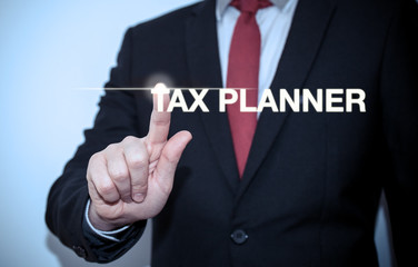 Businessman is pressing button on touch screen interface and selecting "Tax planner". Business concept.