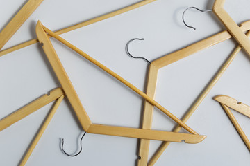 Flat lay of wooden coat hangers on grey background