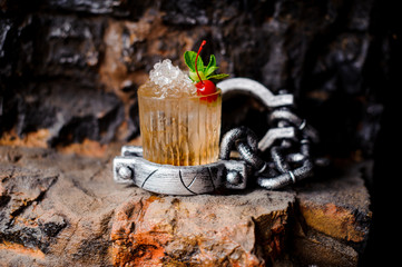 Alcohol cocktail with crushed ice, red cherry and mint.