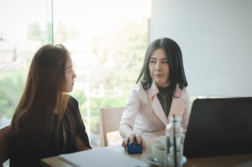 Two women participate business meeting