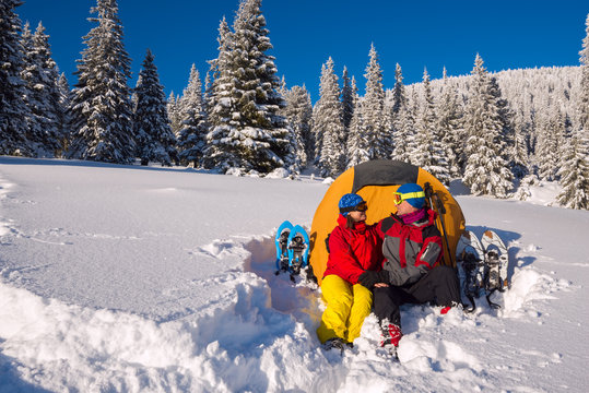 Happy couple during the winter travel in wilderness
