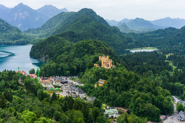 Aerial view from view point on the way to Neuschwanstein castle with scenery of Hohenschwangau castle, lake in schwangau town