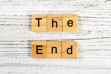 The end sign with wooden blocks on a table
