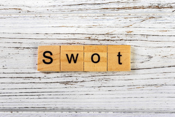 SWOT word made with wooden blocks concept