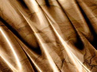 Folds of golden brown silk with marbling effect