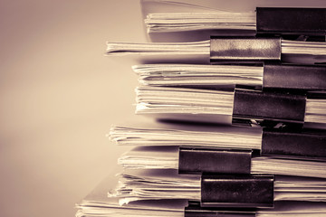 extreamly close up the stacking of office working document with paper clip folder, vintage color...