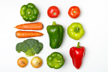 Top view of a set of seasonal vegetables on a white background.  The concept of a healthy diet. Fresh tomatoes, broccoli, carrots, peppers, onion