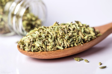 close up  the fennel seed in wooden spoon on white background