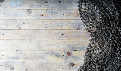 Fishing nets on wooden background. Still-life and objects.