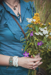 Beautiful woman hands with summer wild flowers bouquet