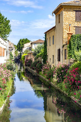 Water canal in orange town in southern France