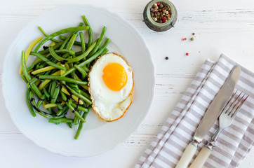 Cooked green beans with fried egg