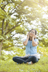 Asian woman listening to the music.