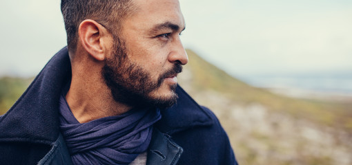 Close up of man with beard standing outdoors