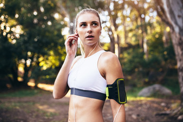 Female runner wearing earphones during workout
