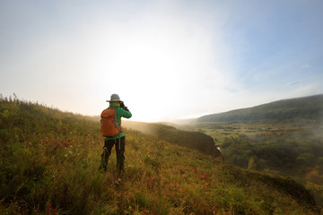 Obraz premium Photographer taking photo in beautiful nature
