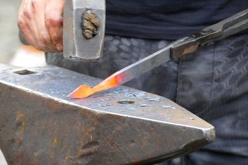 blacksmith wotk with hammer and hot iron