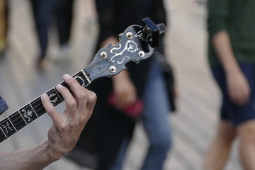 detail of a guitar of a street atr player