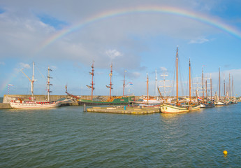 Boats moored along a jetty in sunlight in summer