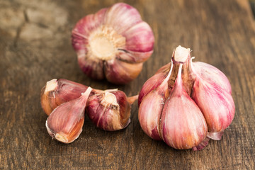 Garlic. Fresh Red Garlic Bulb And Garlic Cloves On Wooden Board Close Up.