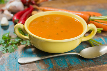 Spicy carrot soup with harissa made from hot chili pepper, lemon, garlic, coriander.