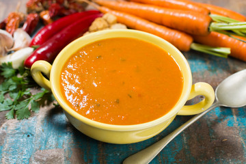 Spicy carrot soup with harissa made from hot chili pepper, lemon, garlic, coriander.