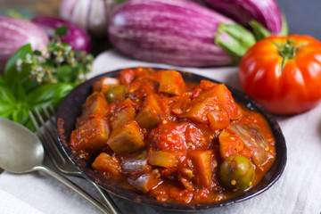 Best italian food - sicilian caponata with eggplants, tomatoes, onion, garlic and herbs